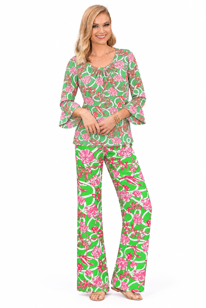 Woman wearing the Green Coral nylon ruffle sleeve top and matching palazzo pants, 2 piece set