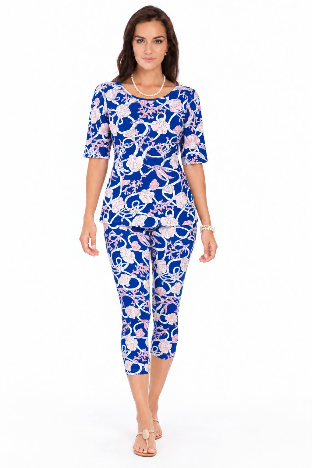 Woman wearing the Royal Baby Pink nylon reversible top and matching capri, 2 piece set