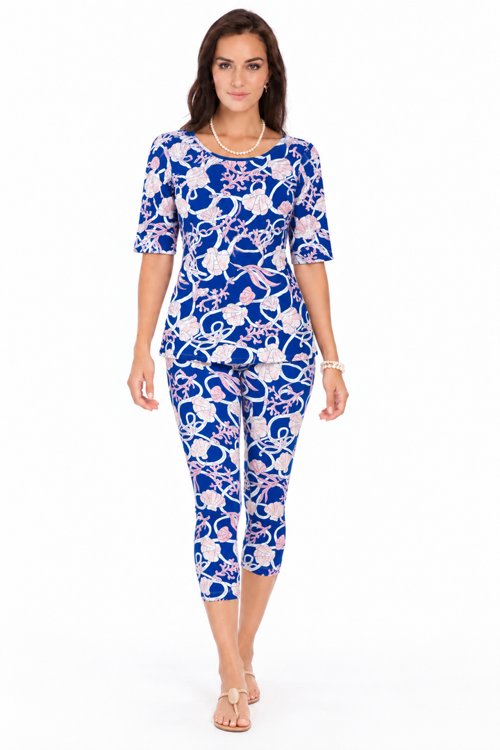 Woman wearing the Royal Baby Pink nylon reversible top and matching capri, 2 piece set