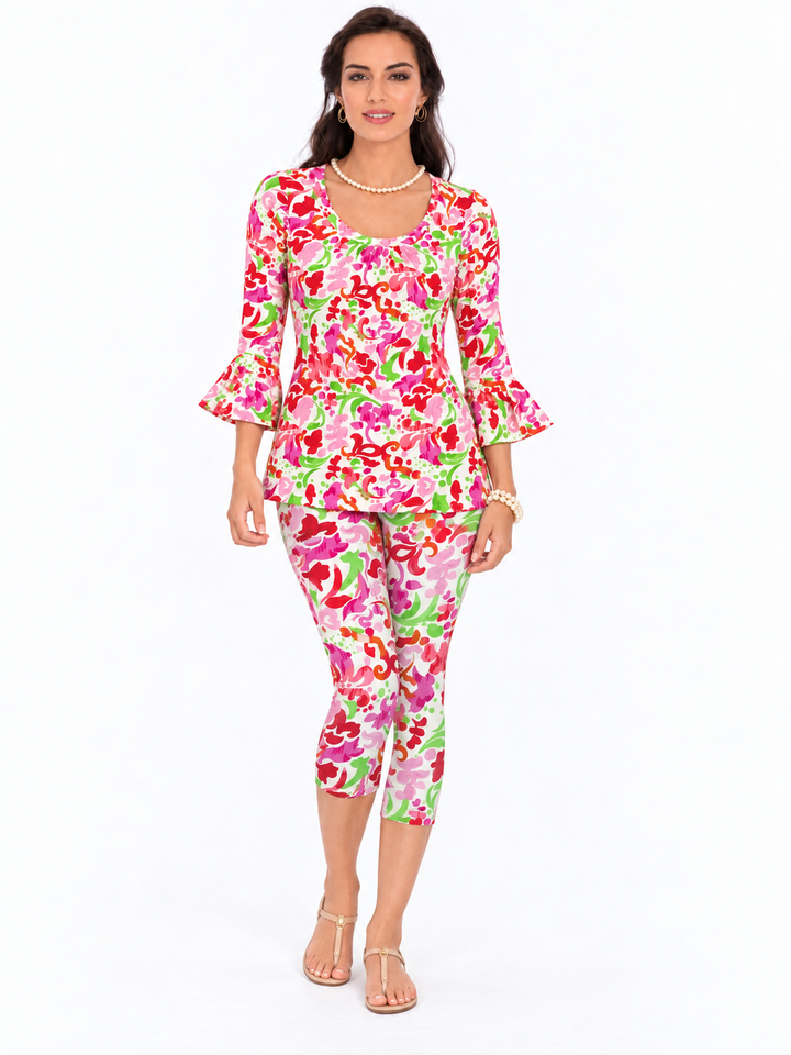 Woman wearing the Pink Melon nylon ruffle sleeve top and matching capri, 2 piece set