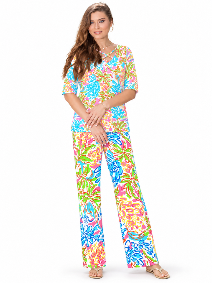 Woman wearing the Tropical Multi nylon reversible top and matching palazzo pants, 2 piece set