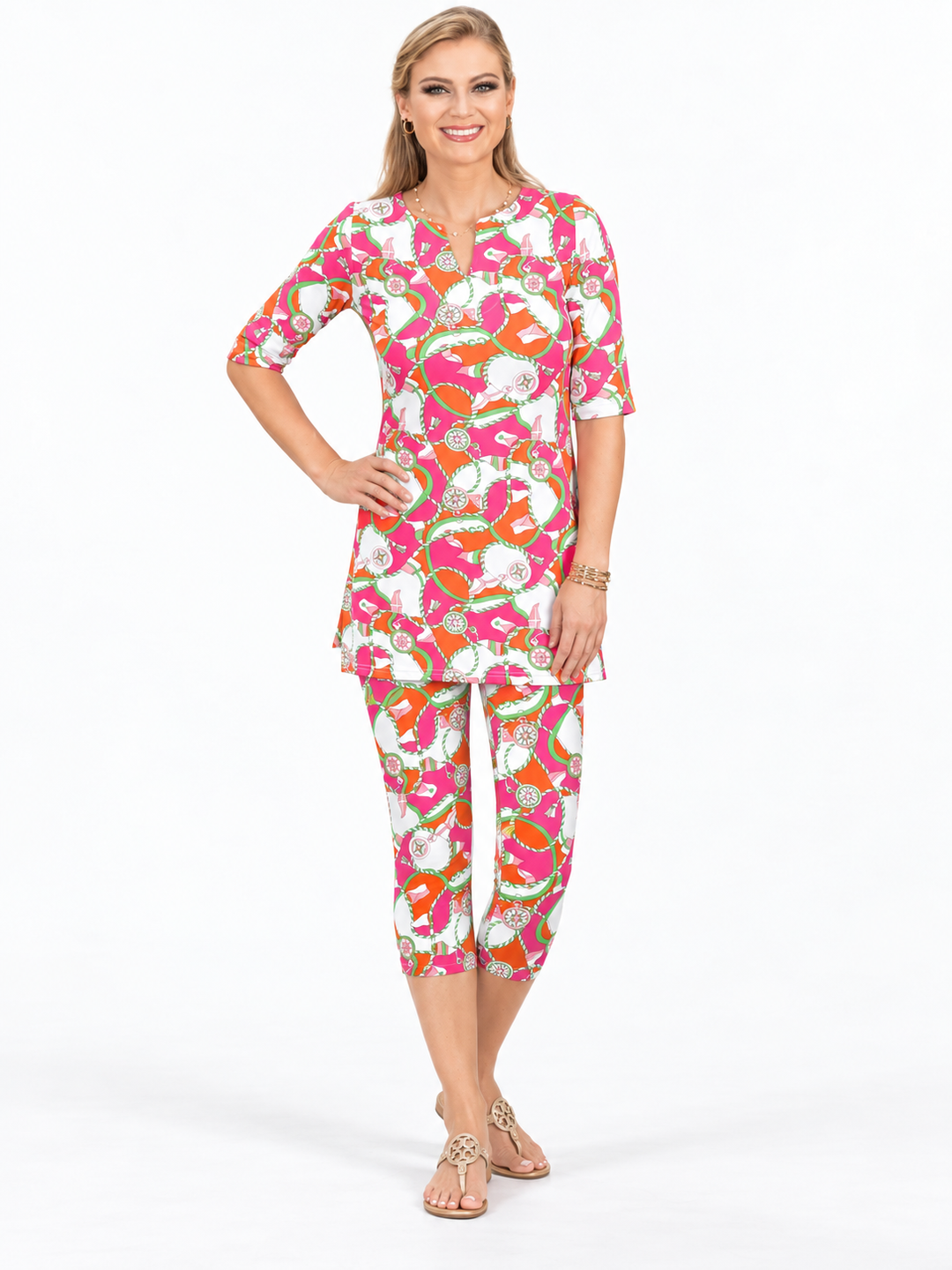 Woman wearing the Tangerine Pink nylon tunic and matching capri, 2 piece set